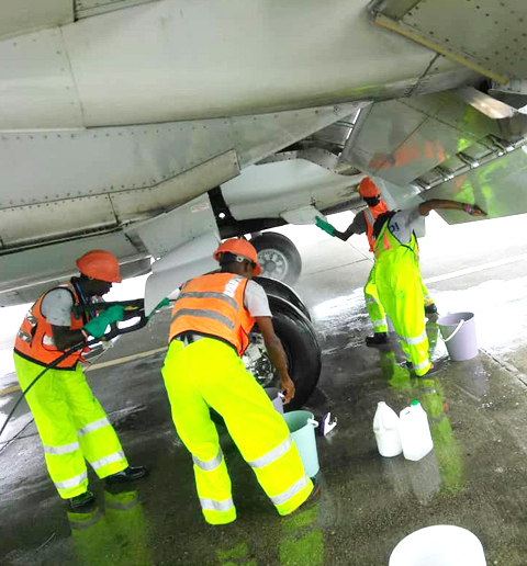 Équipe TropiClean lavant le fuselage d'un avion
